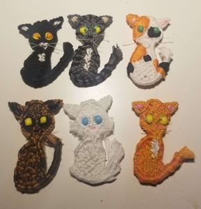 A photo of six woven cats with different coat colors.