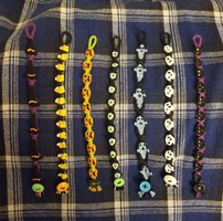 7 Halloween-Themed bracelets depicting various kooky character layed in a row