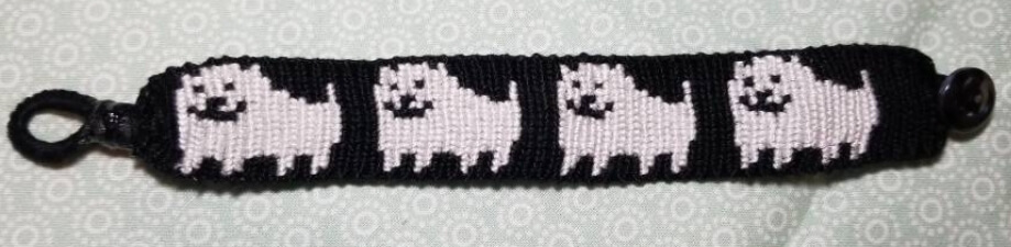A black bracelet with Undertale's Annoying Dog woven into it