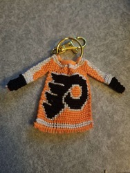 a keychain with a woven jersey-shape made to look like a Philadelphia Flyers hockey team uniform