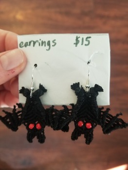 A pair of bat-shaped woven earrings with silver findings.