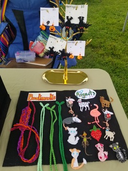 a flat display covered in woven bookmarks and magnets.