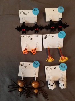 A myriad of halloween themed earrings attached to little cards.