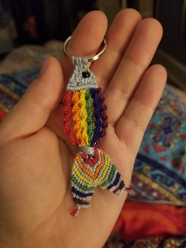 A keychain featuring a fish with twisty rainbow scales.