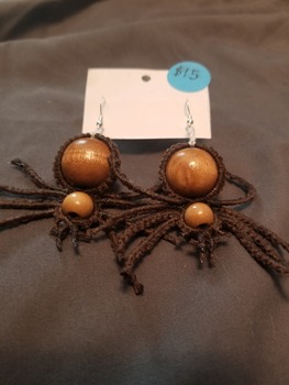 A pair of creepy brown spider earrings with wooden beads and silver findings.